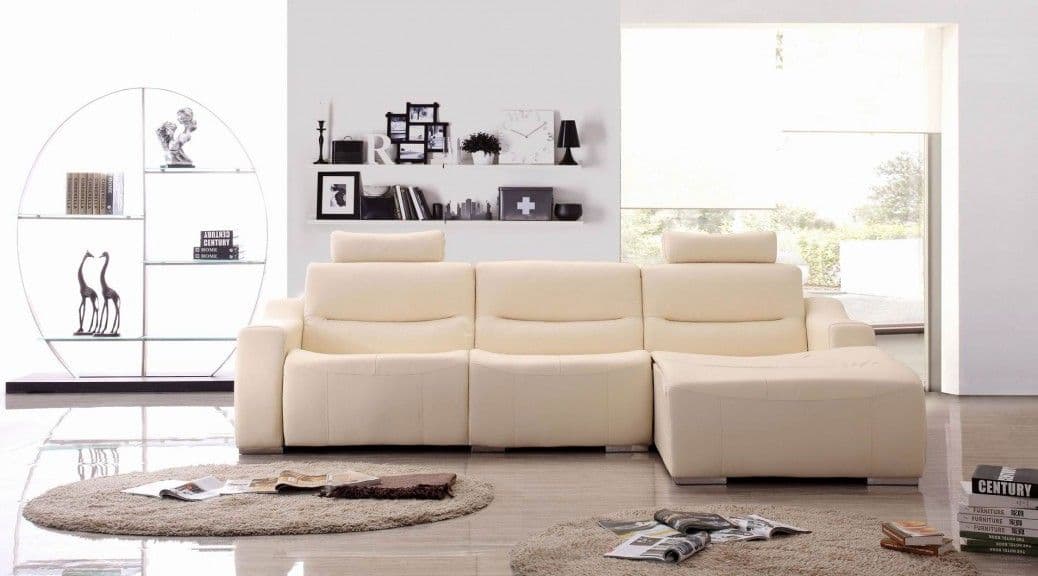 A modern cream sectional sofa with adjustable headrests in a minimalist living room.