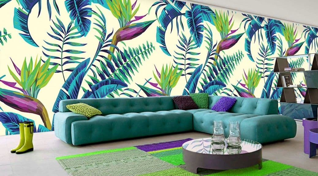 Teal sectional sofa in a vibrant living room with tropical leaf and bird of paradise wallpaper.