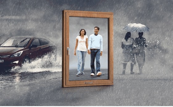A couple walks through a door frame, safe from the surrounding rain and flood.