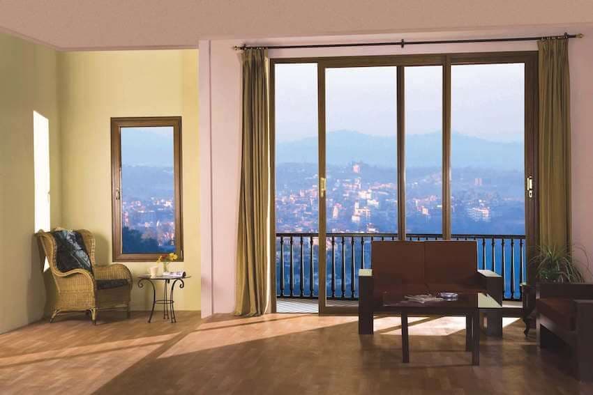 Spacious room featuring large sliding doors, a window, and a panoramic city mountain view.