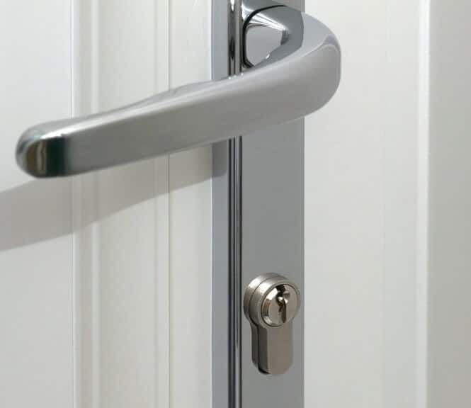 Silver door handle with a keyhole on a white modern door.